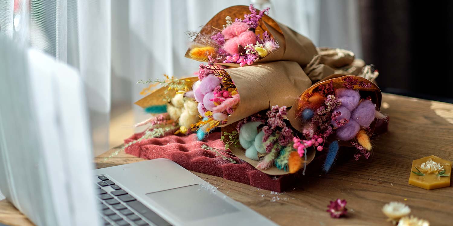 Laptop on desk with flowers