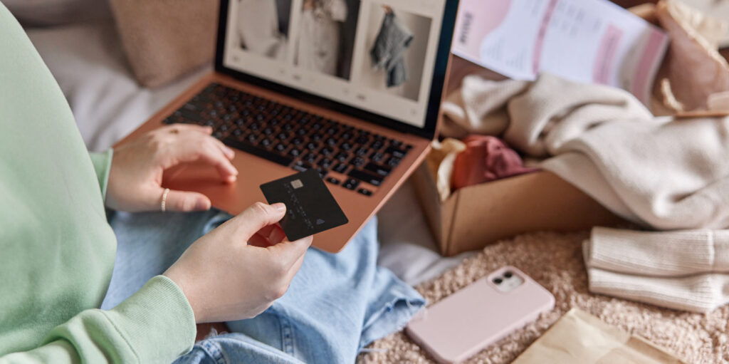 Customer with credit card ready to buy from laptop